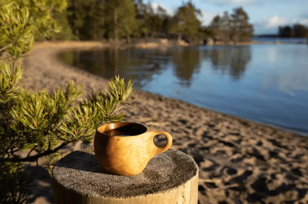 A Kuksa against a lake.