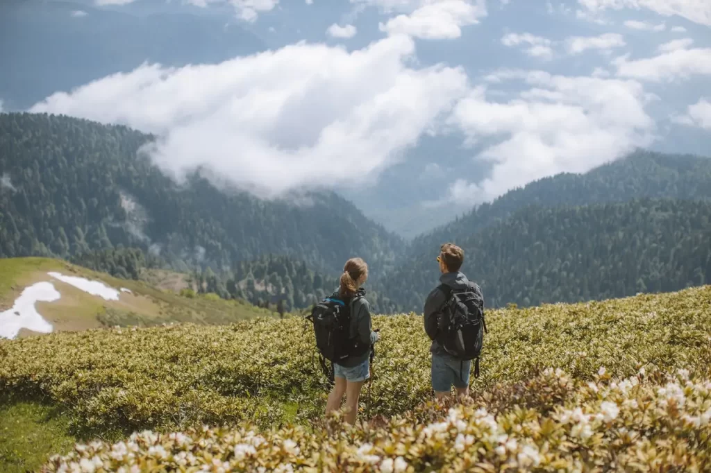 A hiker couple looking at the surrounding view.
