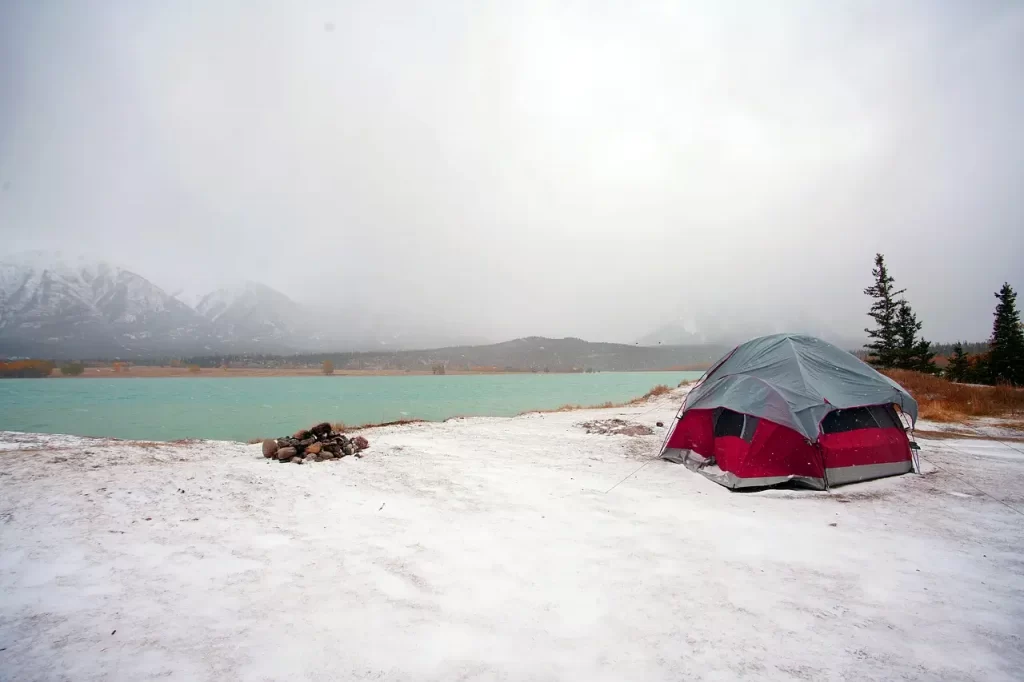 A tent by a lake in winter.