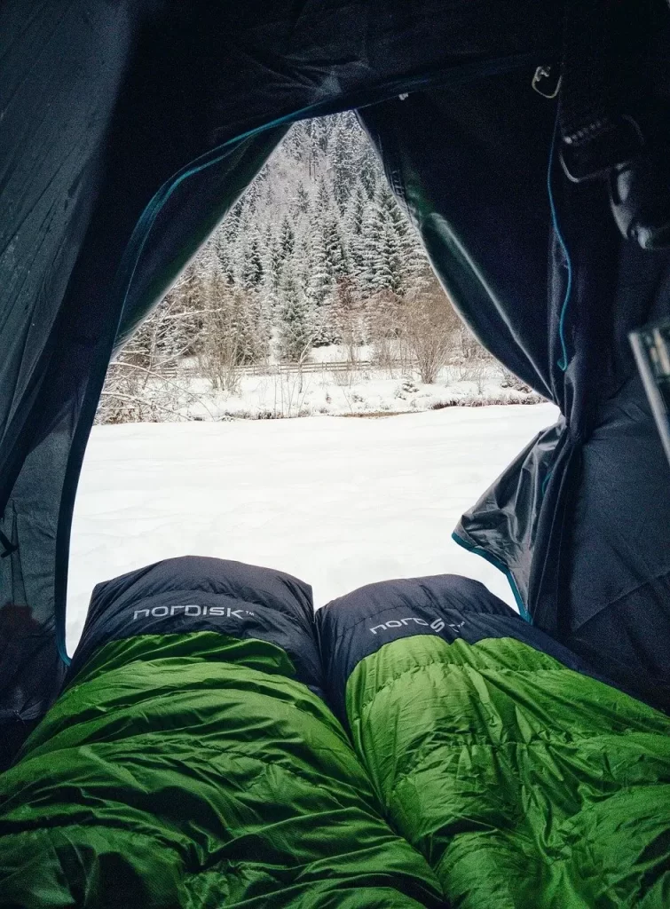 Adjacent sleeping bags in a tent.