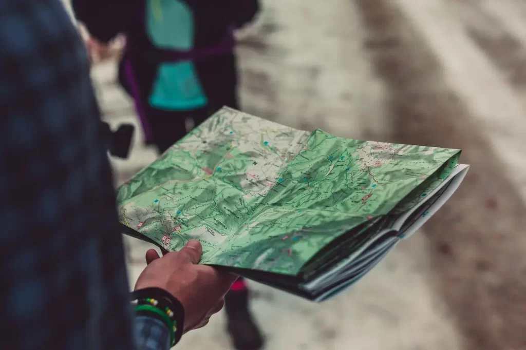 A bushcrafter who is reading a map.